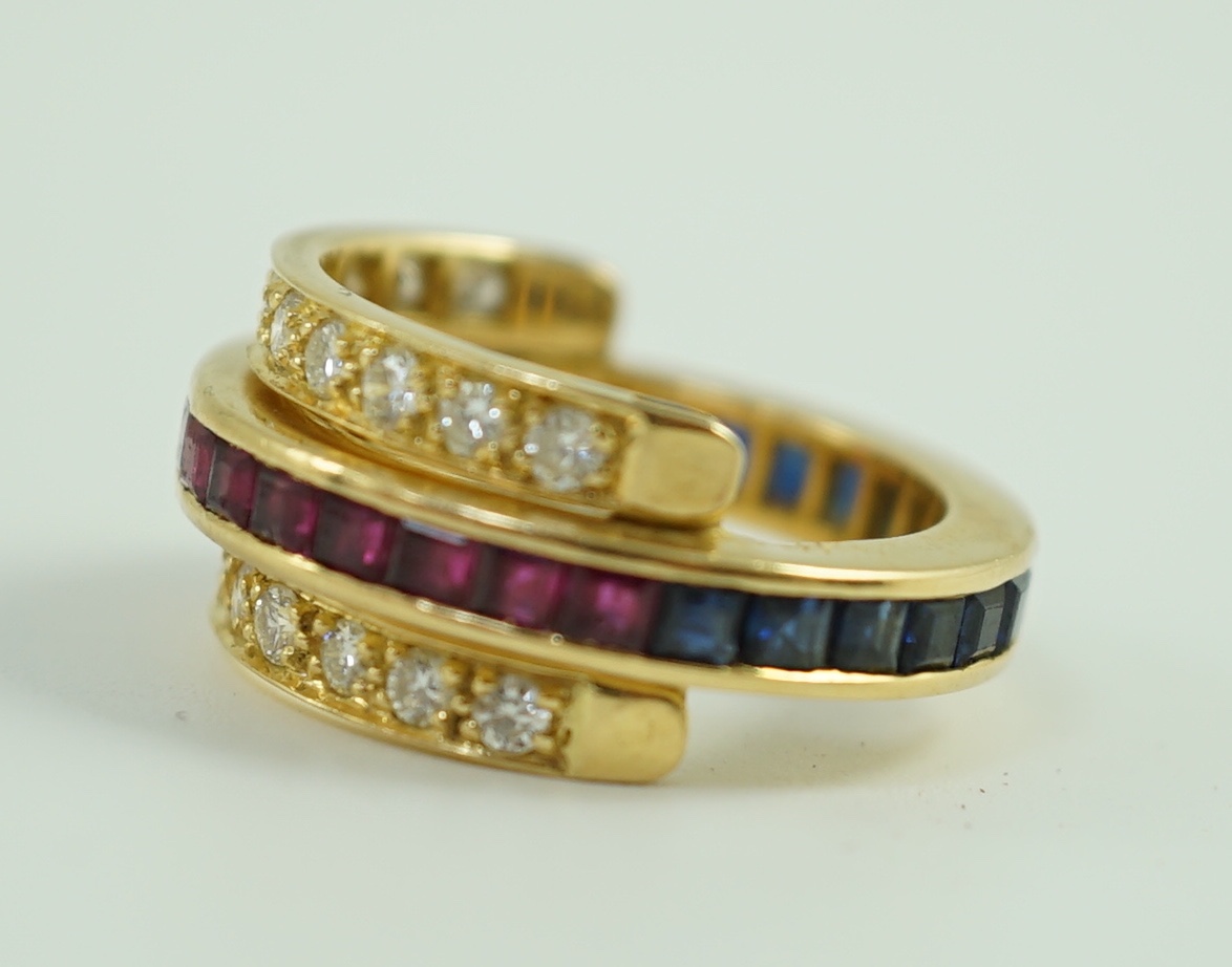 An 18k gold, ruby, sapphire and diamond set triple band swivel ring